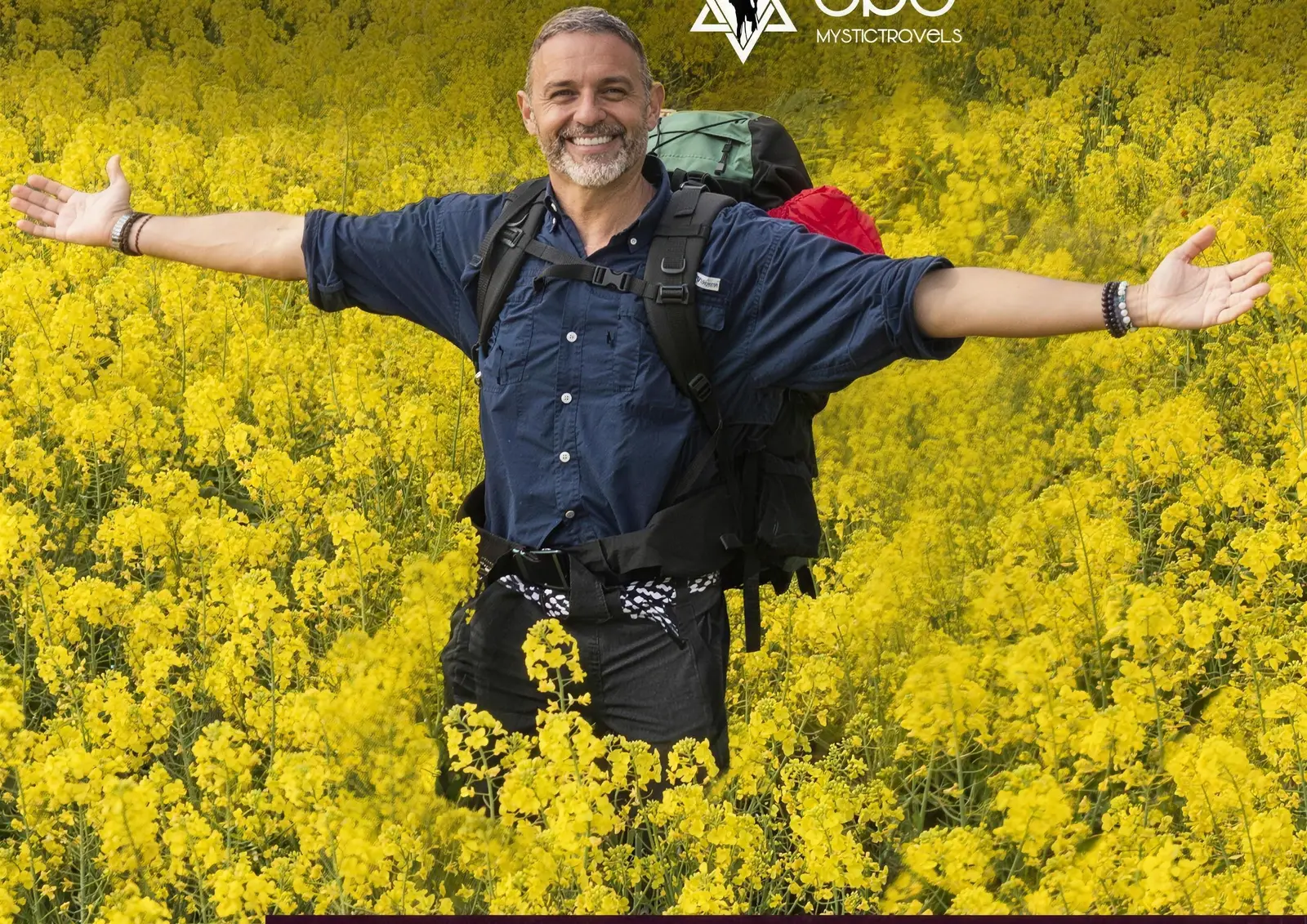 Alejandro with open arms in a yellow rapeseed field