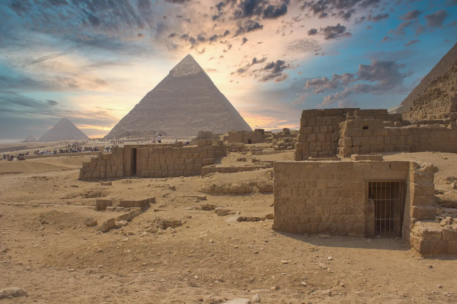 The Pyramids of Giza at dawn under a dramatic sky