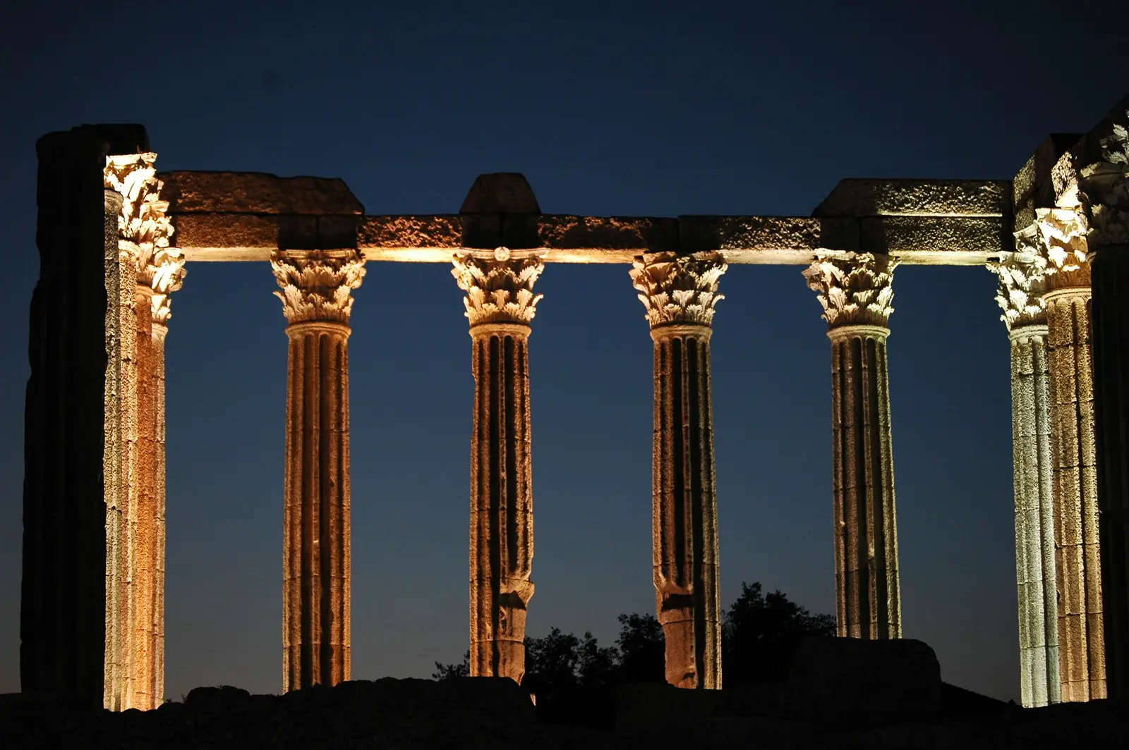 Egyptian temple columns illuminated at night
