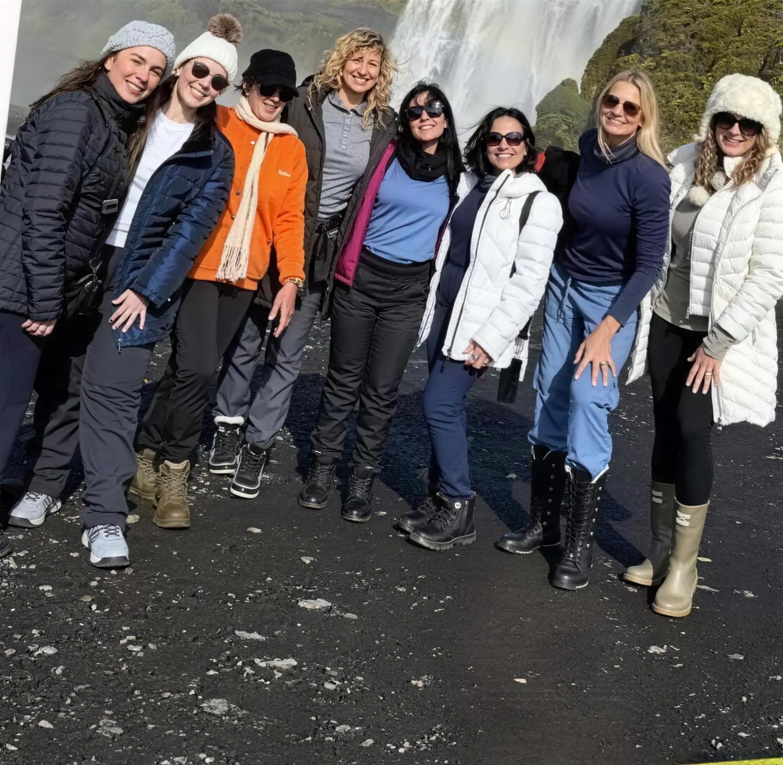 The group posing before Skógafoss waterfall